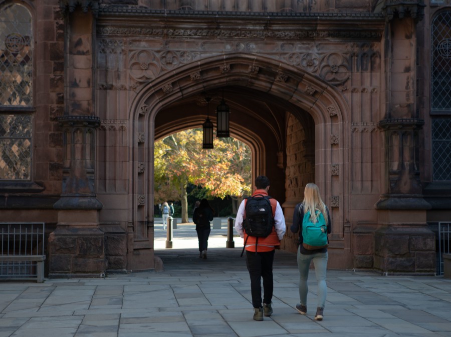 students walking through East Pyne Arch 