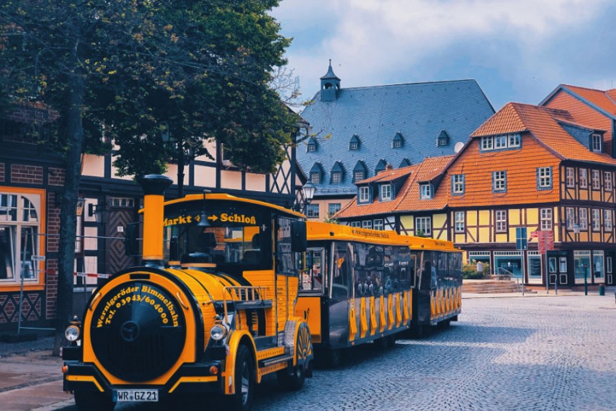 Tram resembling an old train, carrying tourists through old Quedlinburg