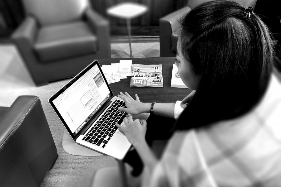 Undergrad student typing on laptop in university environment