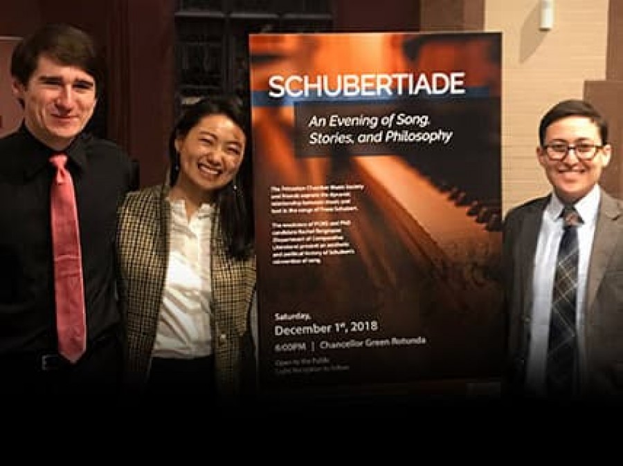 Three students with Schubertiade Poster in East Pyne