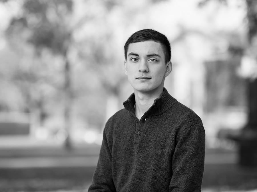 Student in foreground with blurred campus setting in background