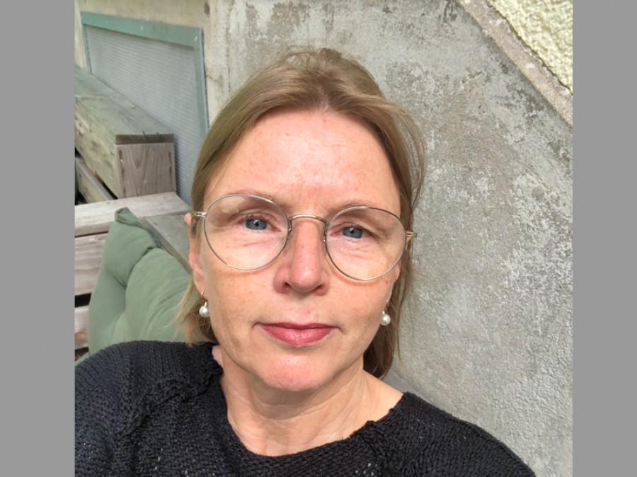 Professor Berndt self portrait on patio with stone wall background