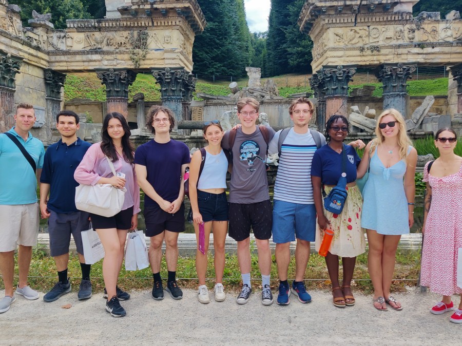 Students grouped together and smiling infront of Vienese structure