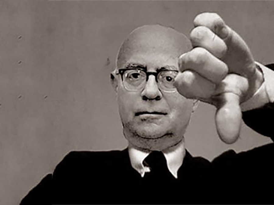 Man facing you, giving sign of thumbs down with left hand