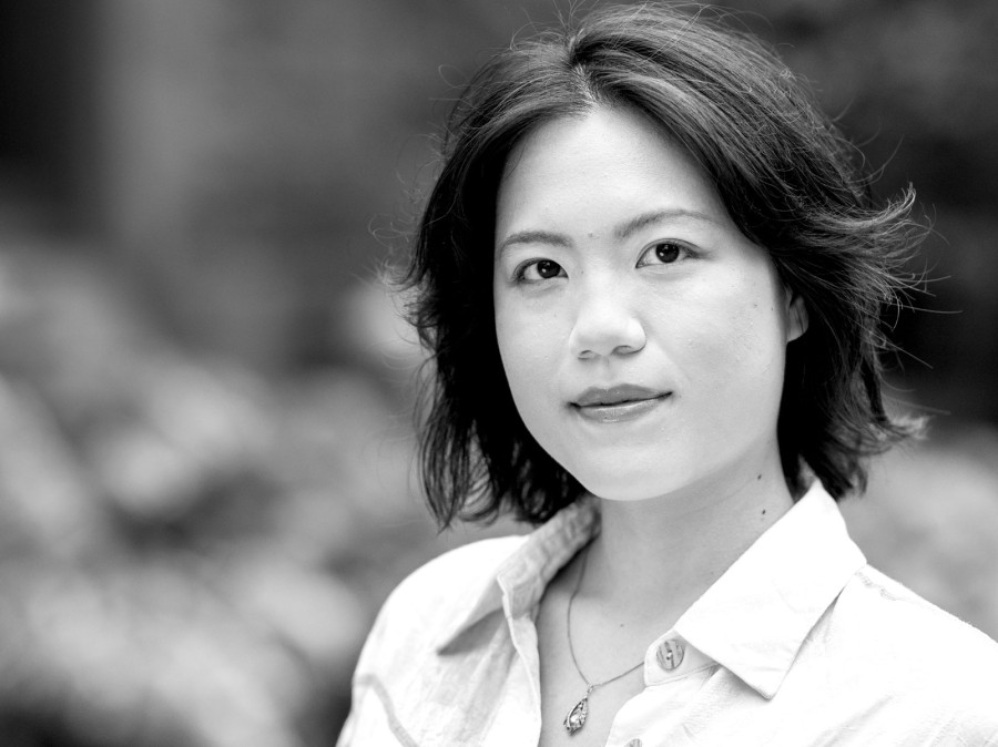 Student facing camera with blurred foliage in background