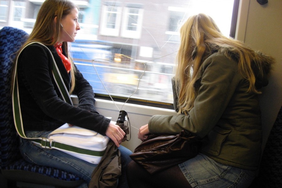 two girls on train, looking out windows